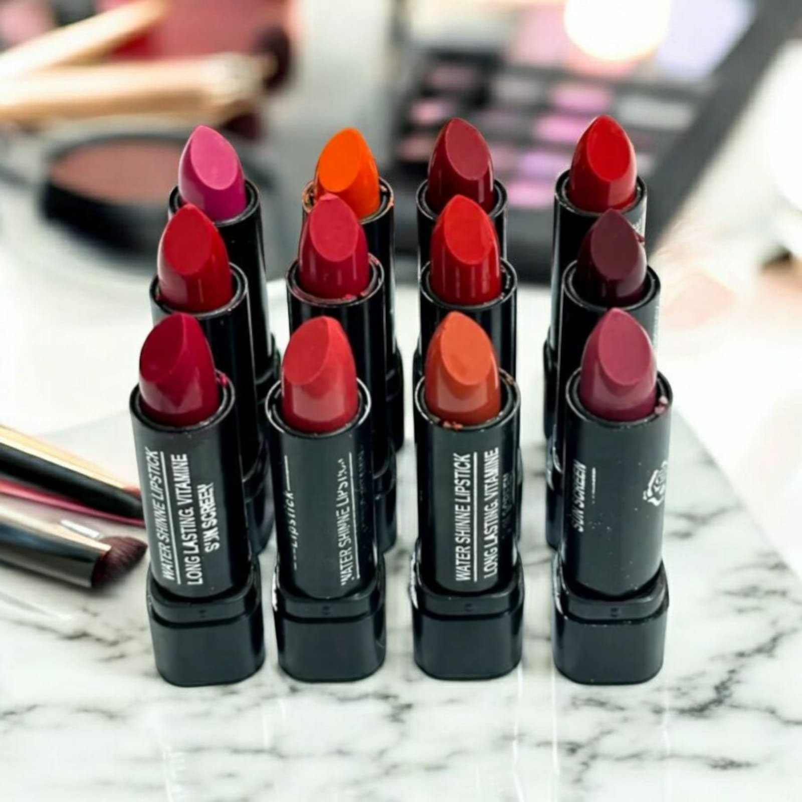 Woman applying matte lipstick from 12 pcs color set